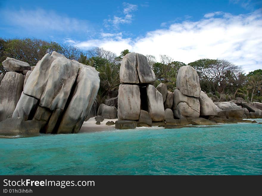 Seychelles stones and palm trees on the bank of azure ocean. Seychelles stones and palm trees on the bank of azure ocean