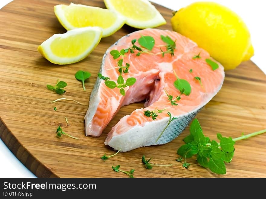 Salmon raw on the wooden background with thyme and