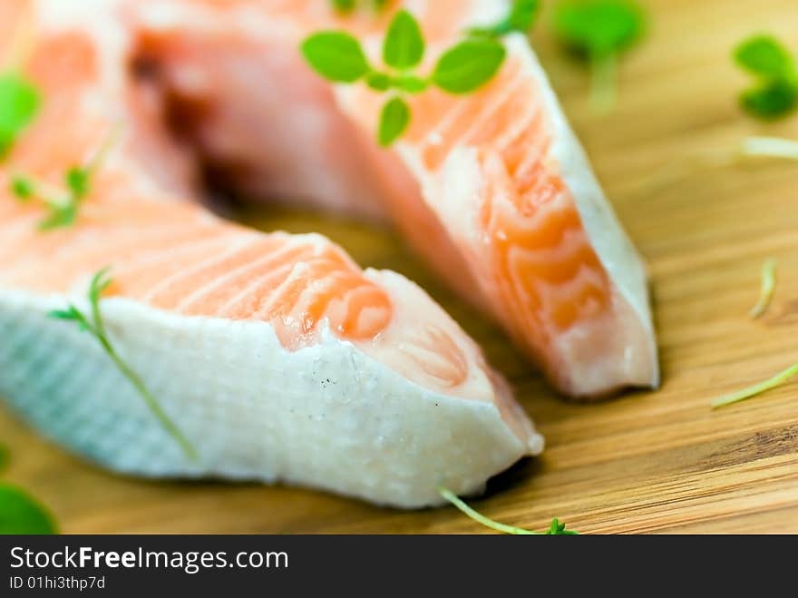 Salmon raw on the wooden background with thyme and