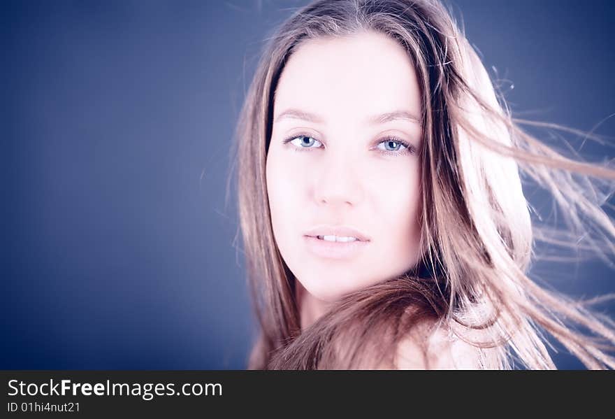 Portrait of attractive girl with fly-away hair on the wind. Pastel toned image. Portrait of attractive girl with fly-away hair on the wind. Pastel toned image