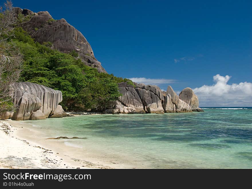 Seychelles stones and palm trees on the bank of azure ocean. Seychelles stones and palm trees on the bank of azure ocean