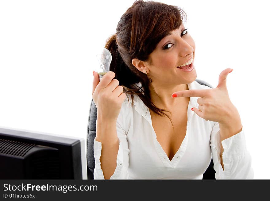 Portrait of smiling woman indicating receiver against white background