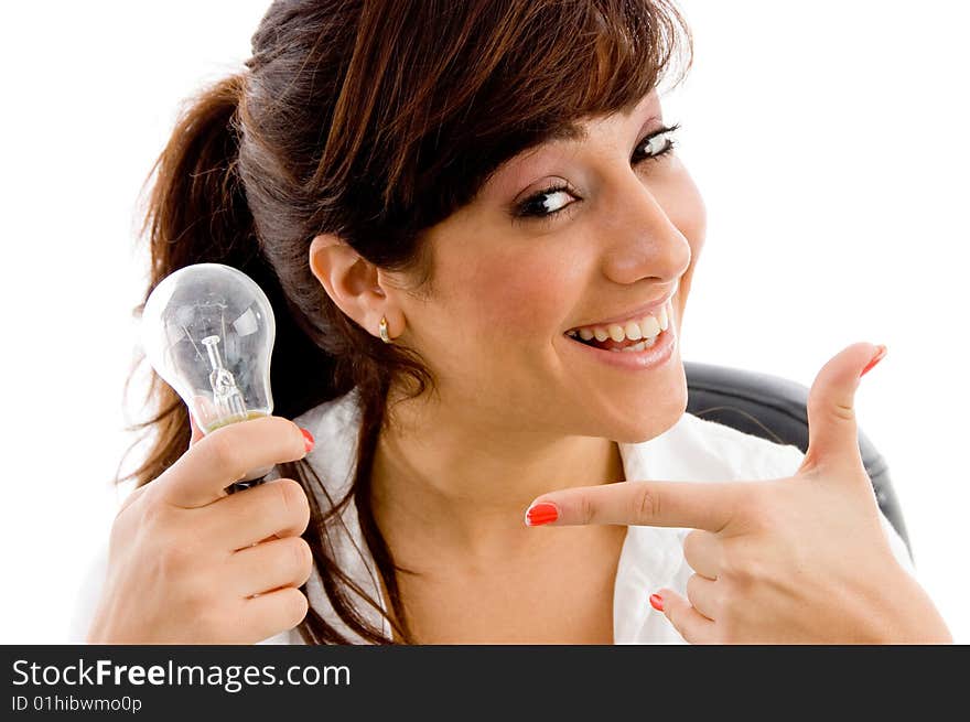 Portrait of smiling woman indicating bulb on an isolated white background