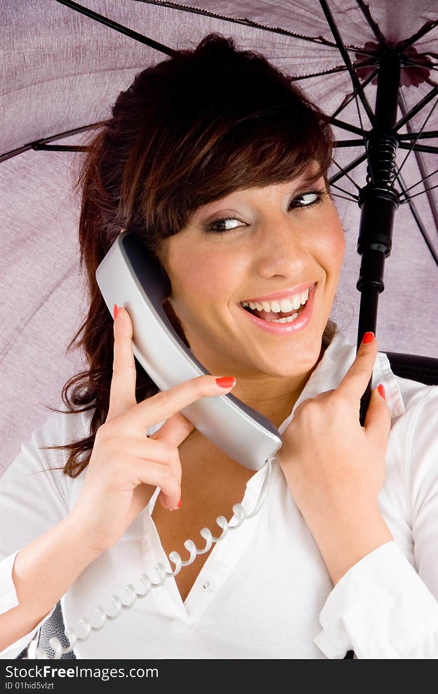 Woman talking on phone and holding an umbrella