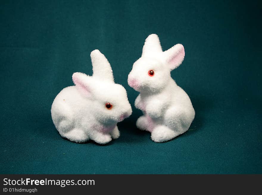 White rabbits on the dark background as Easter symbol