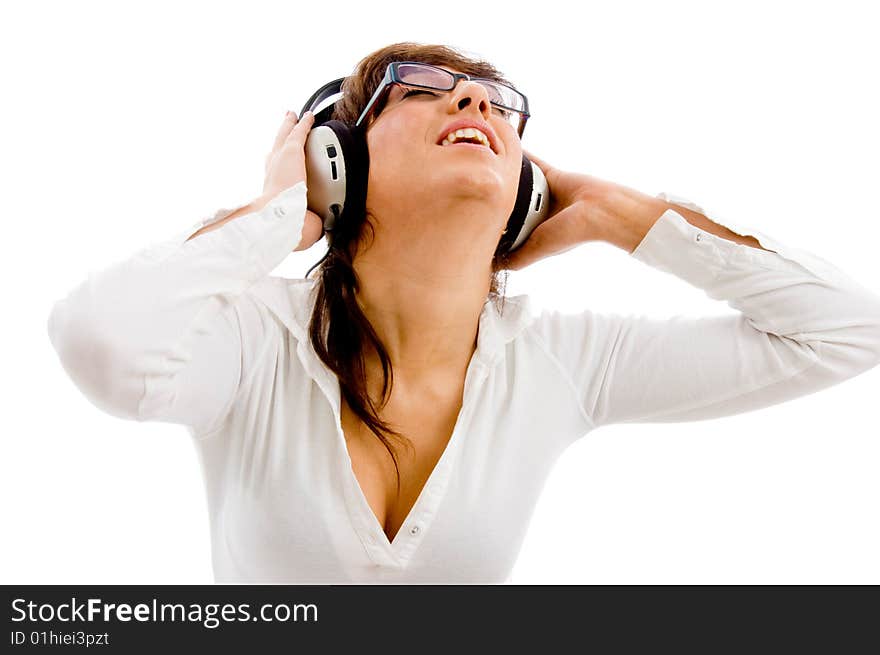 Portrait of young female listening music on an isolated white background