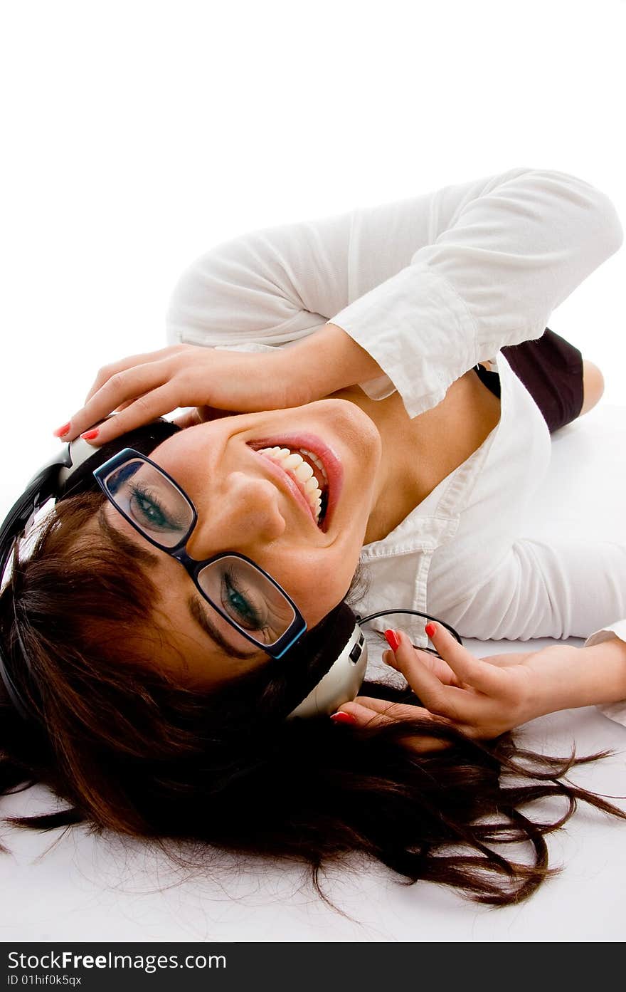 Top view of smiling female enjoying music on an isolated white background