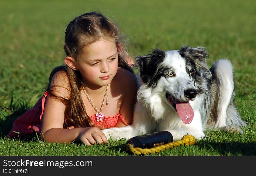 Girl and her dog having a rest after playing. Girl and her dog having a rest after playing