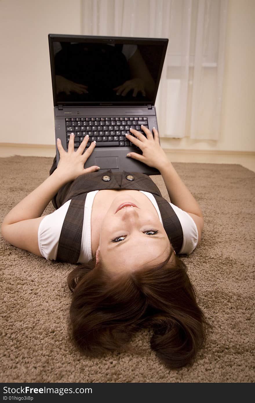 Woman with laptop on carpet