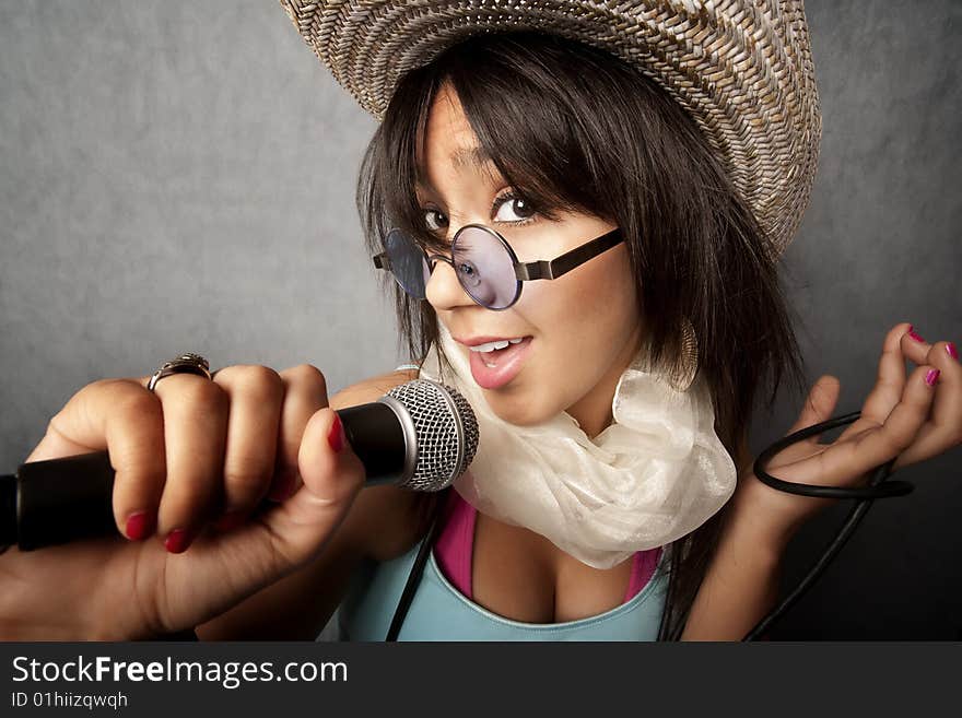 Pretty young singer with a large microphone. Pretty young singer with a large microphone