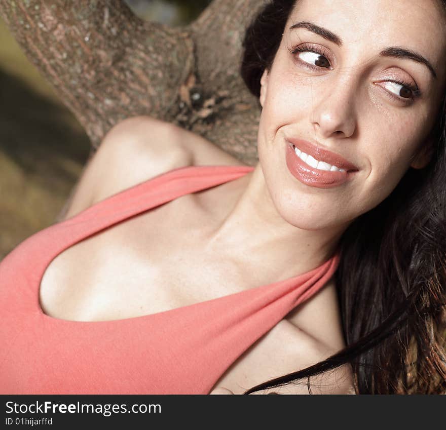 Beautiful young woman glancing away and smiling. Beautiful young woman glancing away and smiling