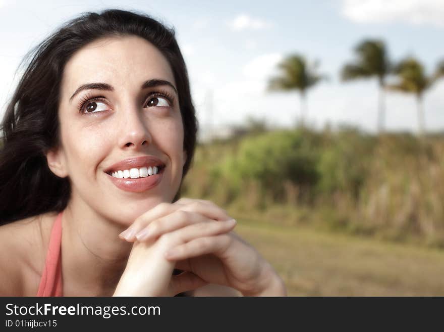 Beautiful young woman smiling and glancing away. Beautiful young woman smiling and glancing away