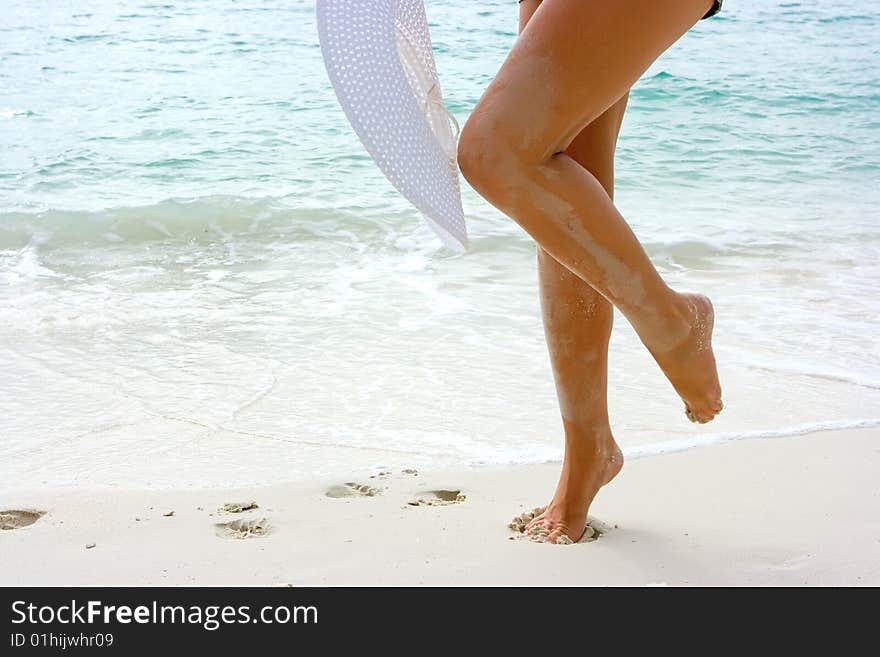 Woman With White Hat On The Beach