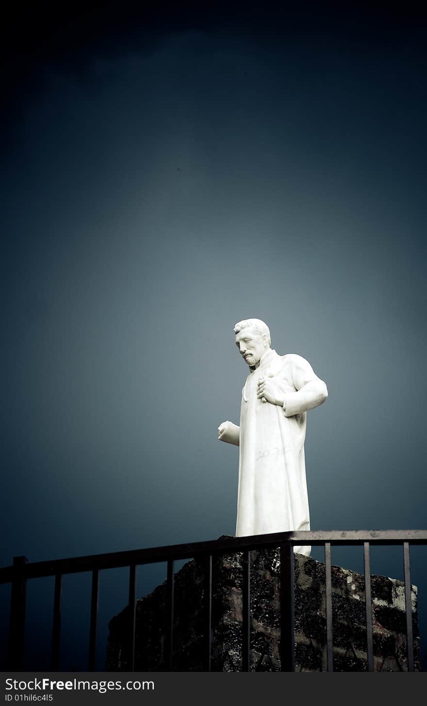 Lonely white thinker sculpture against cloudy sky