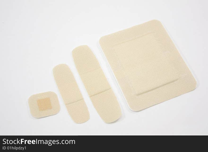 Fours sizes of bandages isolated on a white background. Fours sizes of bandages isolated on a white background.