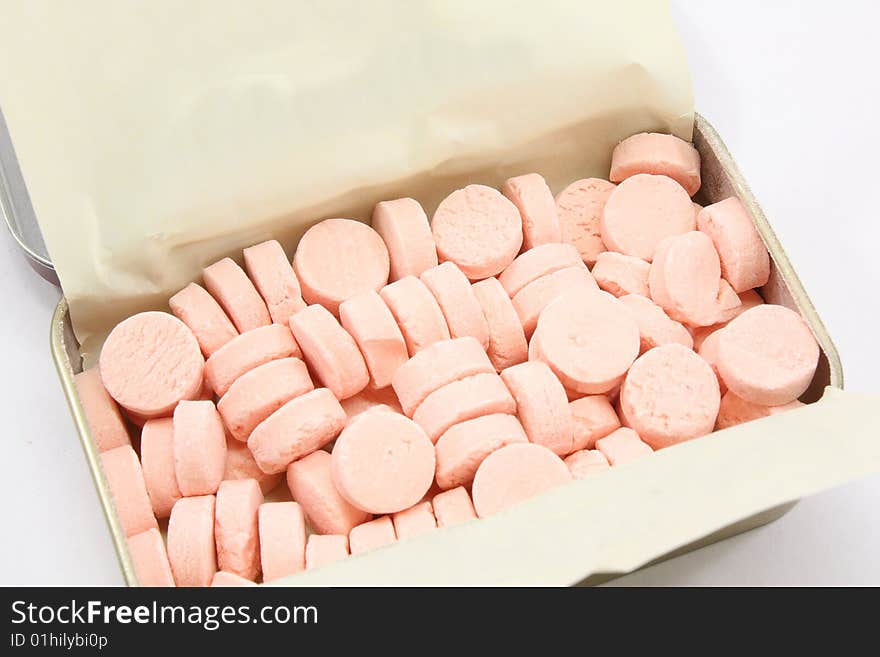 Tin of red mints isolated on a white background. Tin of red mints isolated on a white background.