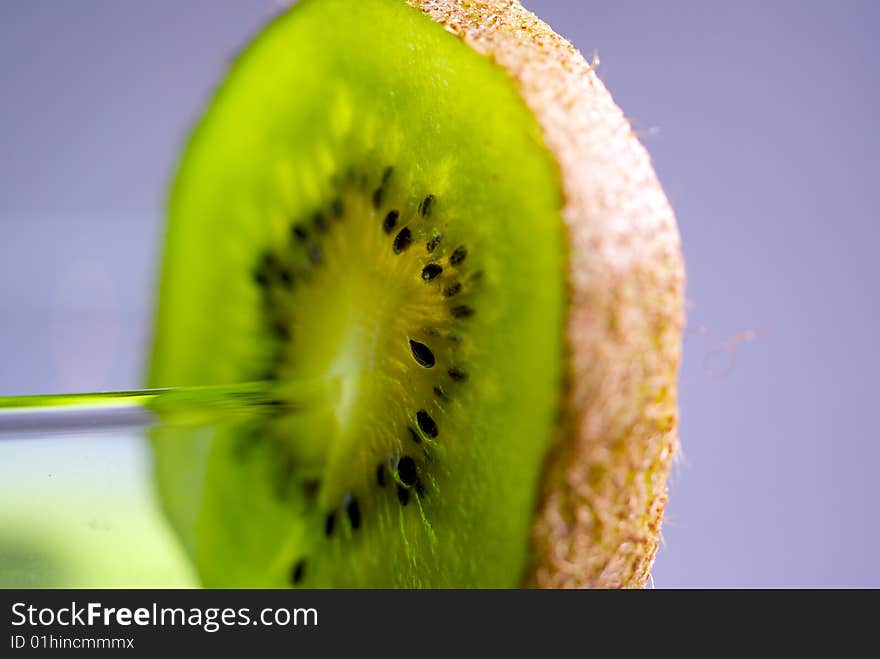 A kiwi slid onto a small glass. A kiwi slid onto a small glass.