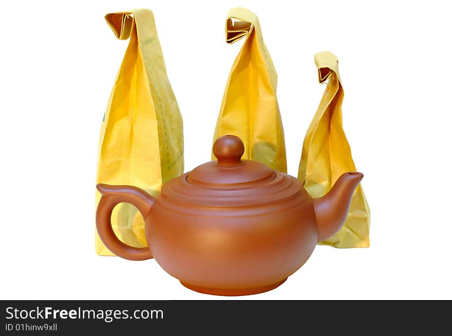 Pottery (clay) teapot and tea in paper bags.