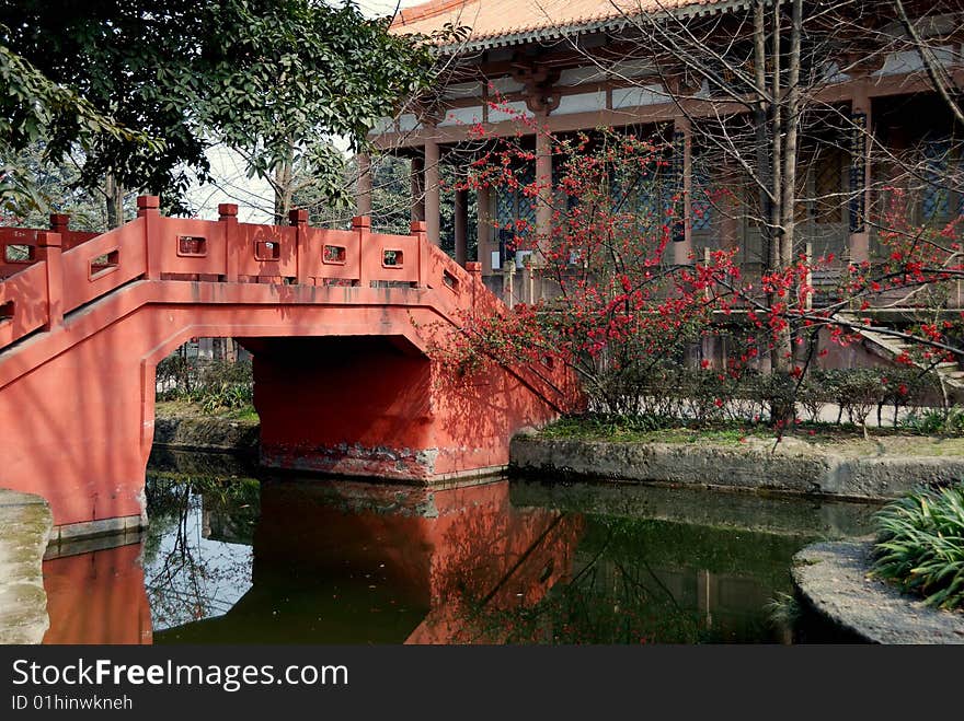Traditional Chinese bridge over a quiet canal leads to the Buddhist Temple prayer hall at Wang Cong Ci Park - Xu Lei Photo / Lee Snider Photo Images. Traditional Chinese bridge over a quiet canal leads to the Buddhist Temple prayer hall at Wang Cong Ci Park - Xu Lei Photo / Lee Snider Photo Images.
