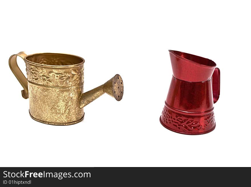 Two small metal watering cans on white background. Two small metal watering cans on white background.