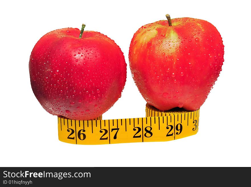 Depicted are two red apples on the measuring tape - isolated over white. Depicted are two red apples on the measuring tape - isolated over white