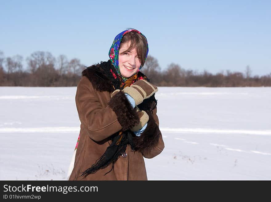 Girl in russian traditional clothes against  winter landscape