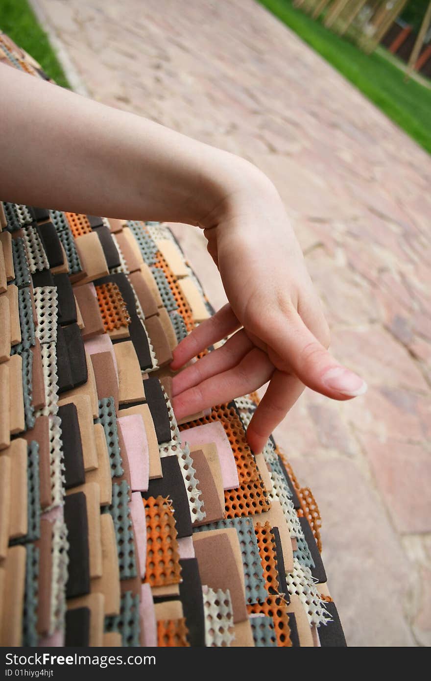 Woman touching a bench composed of rubber plates. Woman touching a bench composed of rubber plates