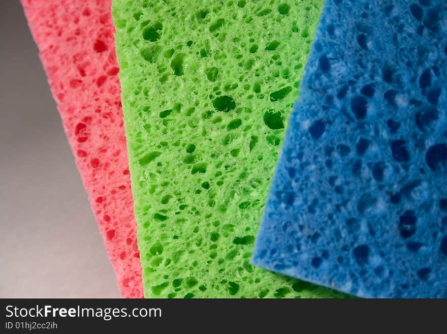 Close-up of multicolor sponges for cleaning. Can be used as a background and to focus on the sponge structure. Close-up of multicolor sponges for cleaning. Can be used as a background and to focus on the sponge structure