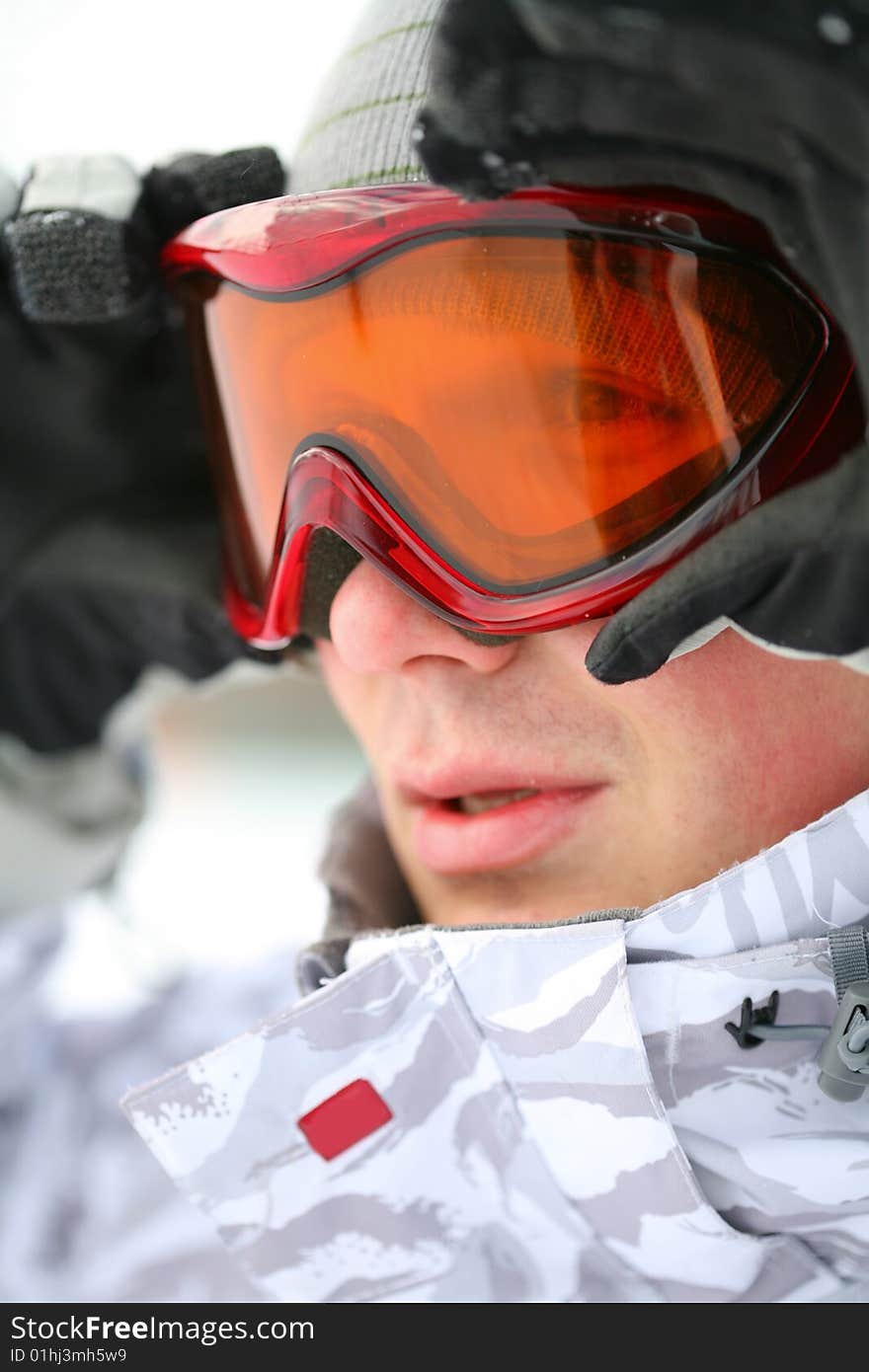 Snowboarder looking in goggles