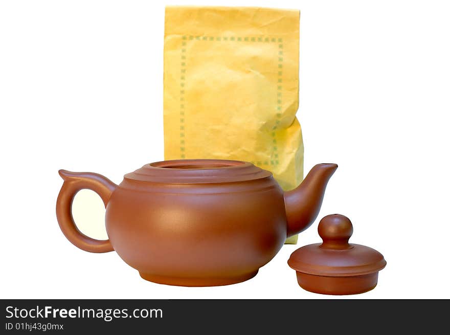 Chinese pottery (clay) teapot and tea in paper bags on isolated background. Chinese pottery (clay) teapot and tea in paper bags on isolated background.