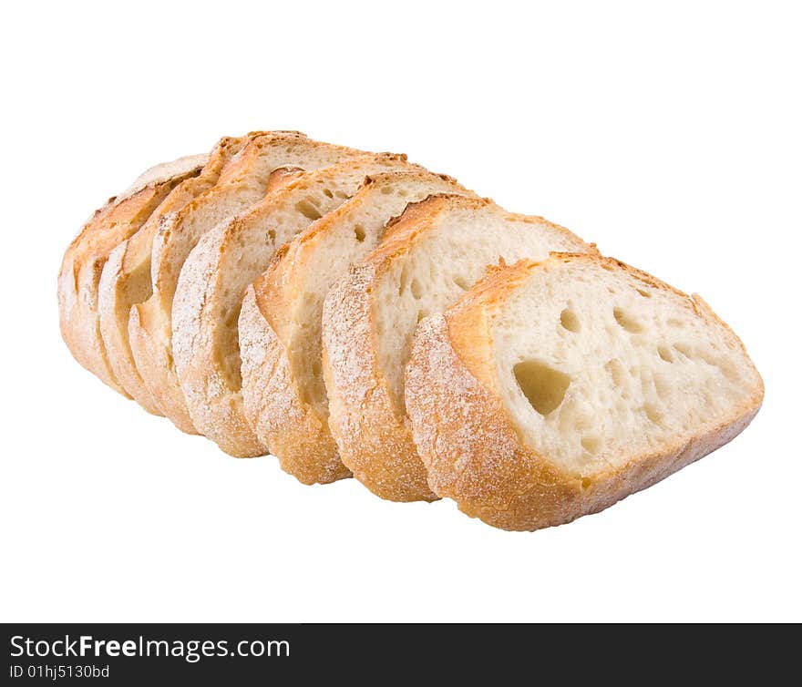 Fresh village bread cut on slices isolated at the white background