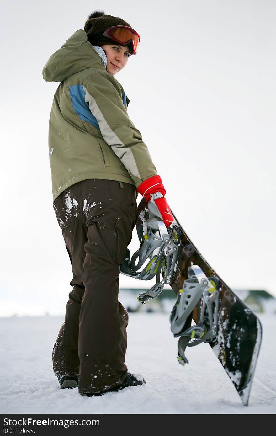 Young adult female snowboarder