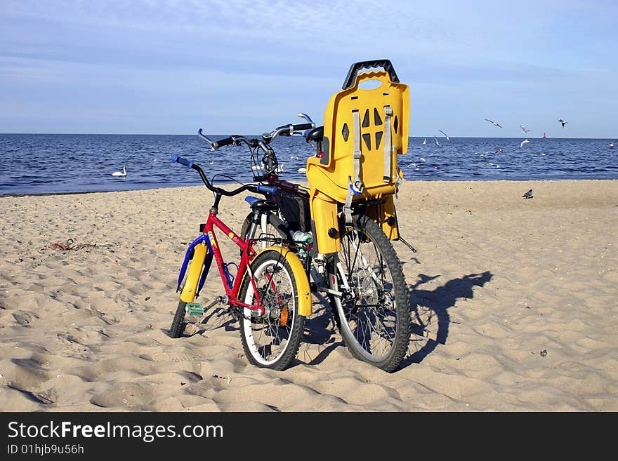 Two standing bicycles on the beach. Two standing bicycles on the beach