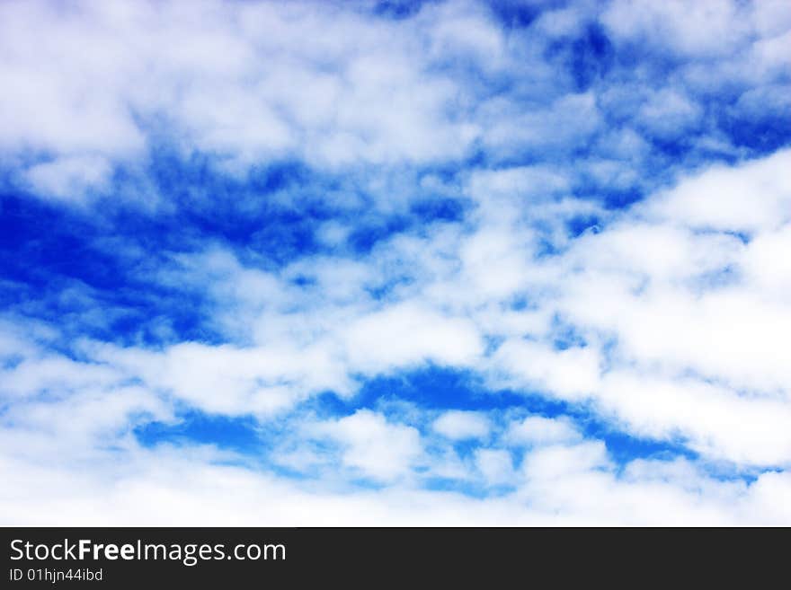 Aerial view of cloudy blue sky from aircraft window. Aerial view of cloudy blue sky from aircraft window.