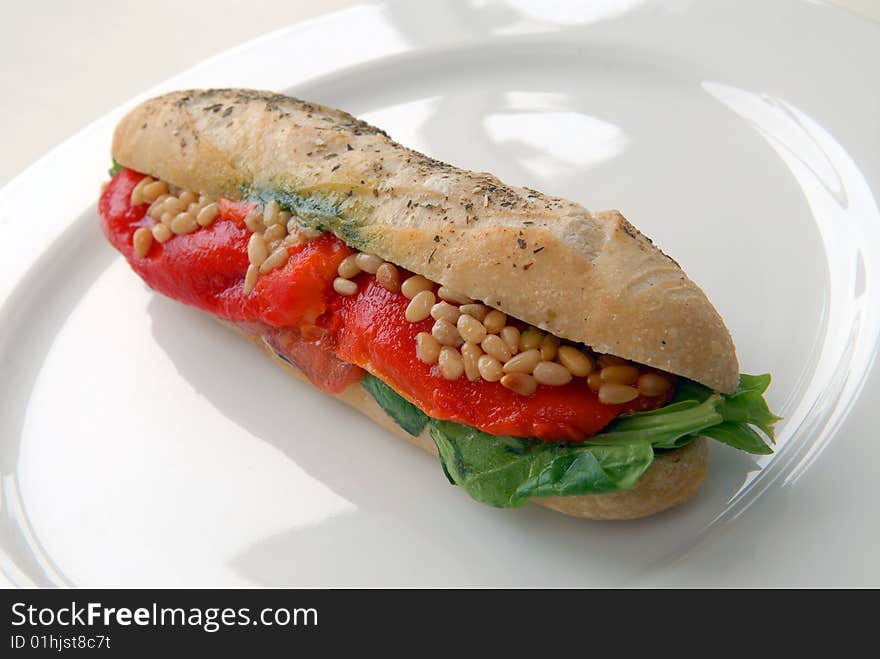 Sandwich with a salmon on a white plate