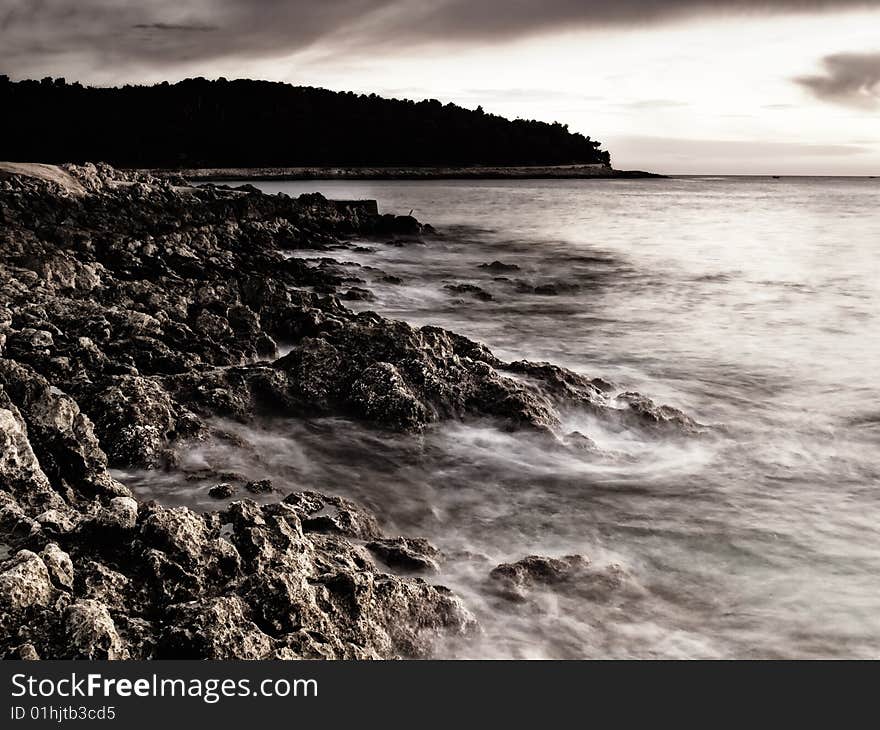 Sunset on the beach.Rocky Adriatic coast on the island Losinj, Croatia. This portfolio contains color version of this image. Sunset on the beach.Rocky Adriatic coast on the island Losinj, Croatia. This portfolio contains color version of this image.