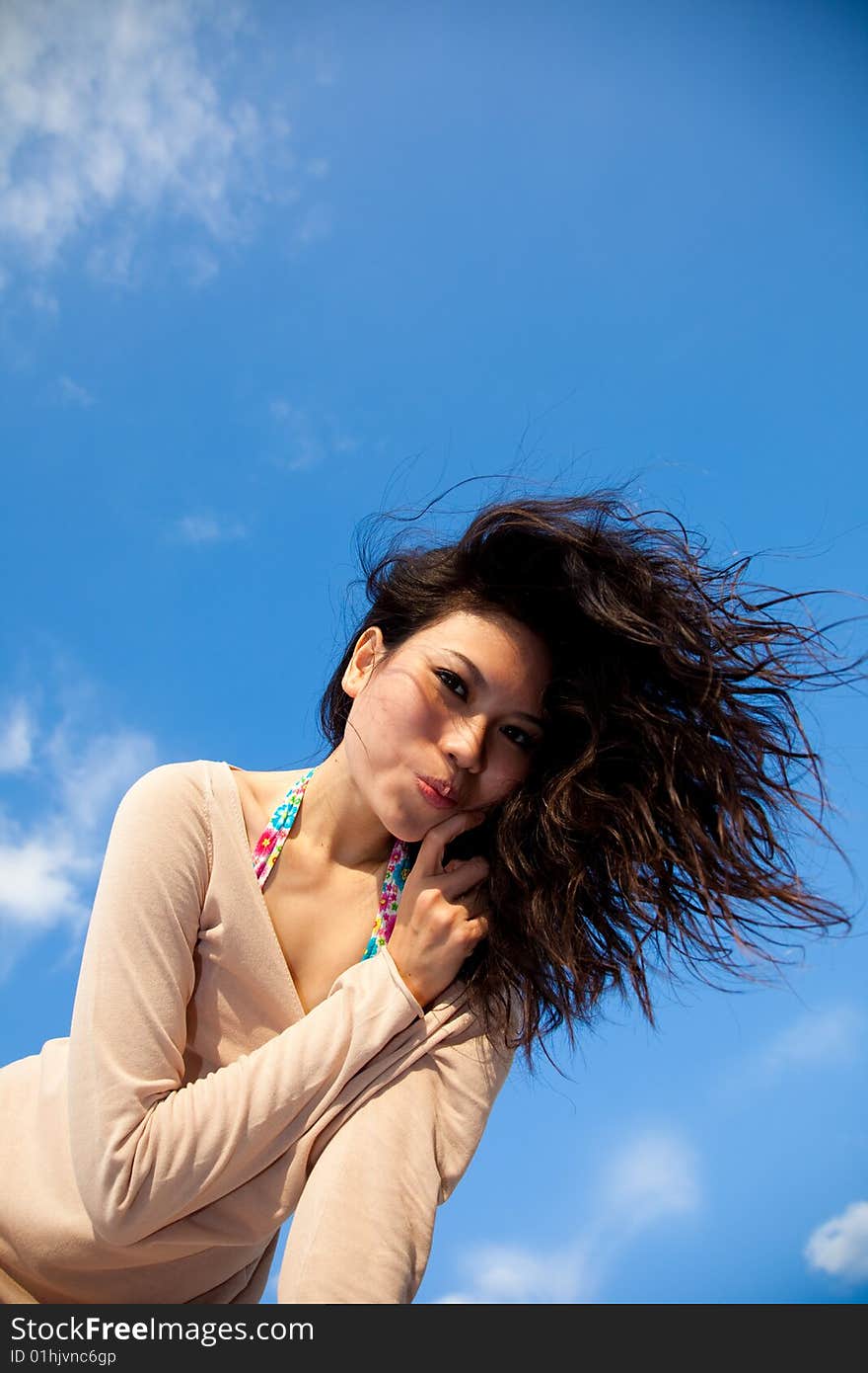 Happy young woman with blue sky