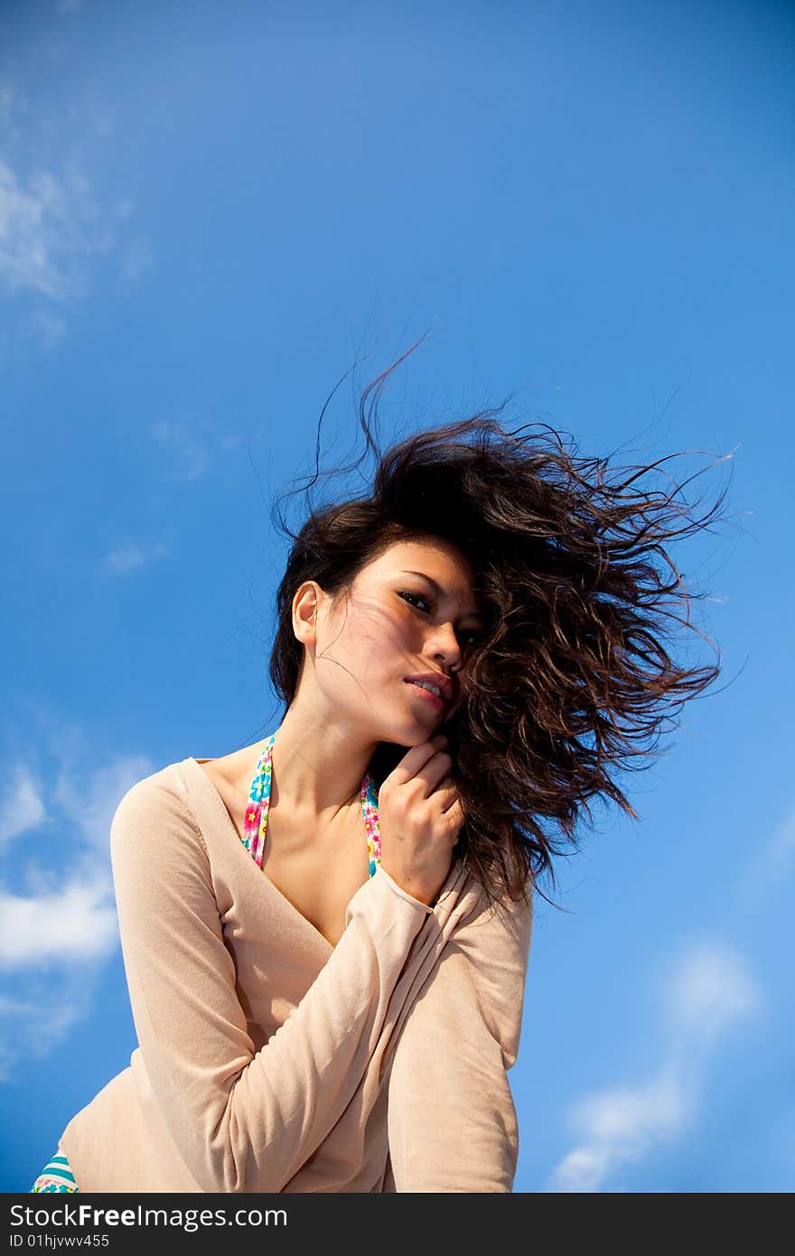 Happy young woman with blue sky