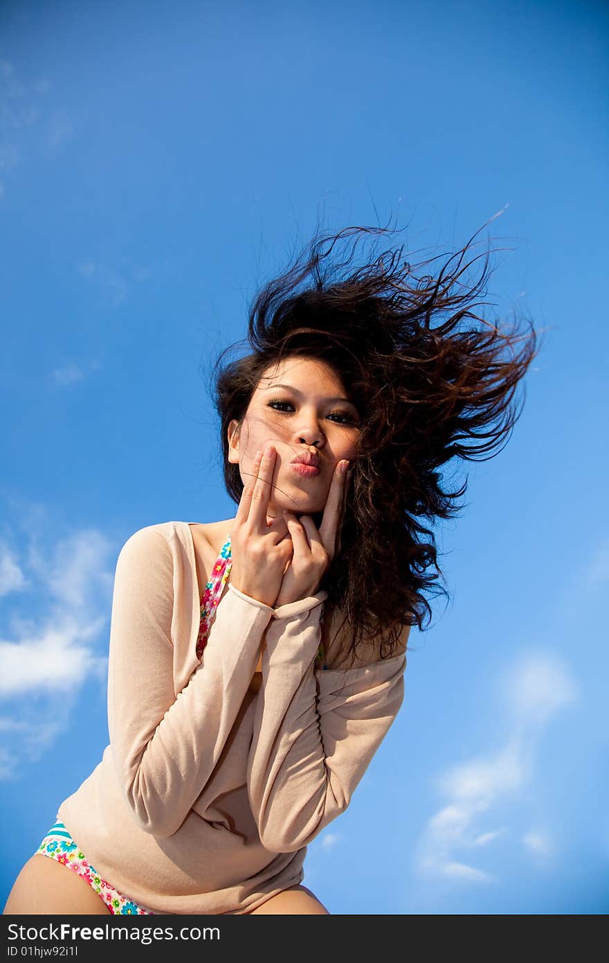 Happy young woman with blue sky