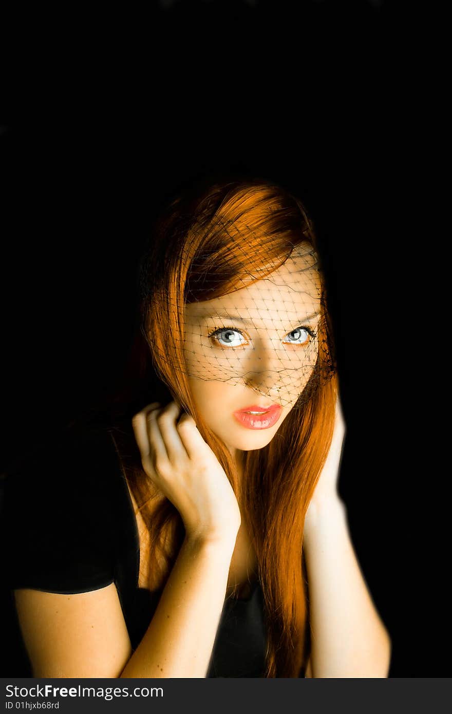 Beautiful young woman with a black background