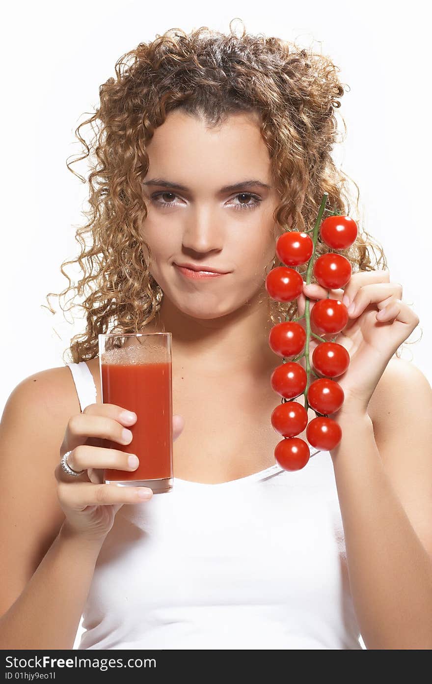 Half body portrait of young woman holding glass of tomato juice and tomatoes on vine, isolated on white background. Half body portrait of young woman holding glass of tomato juice and tomatoes on vine, isolated on white background.