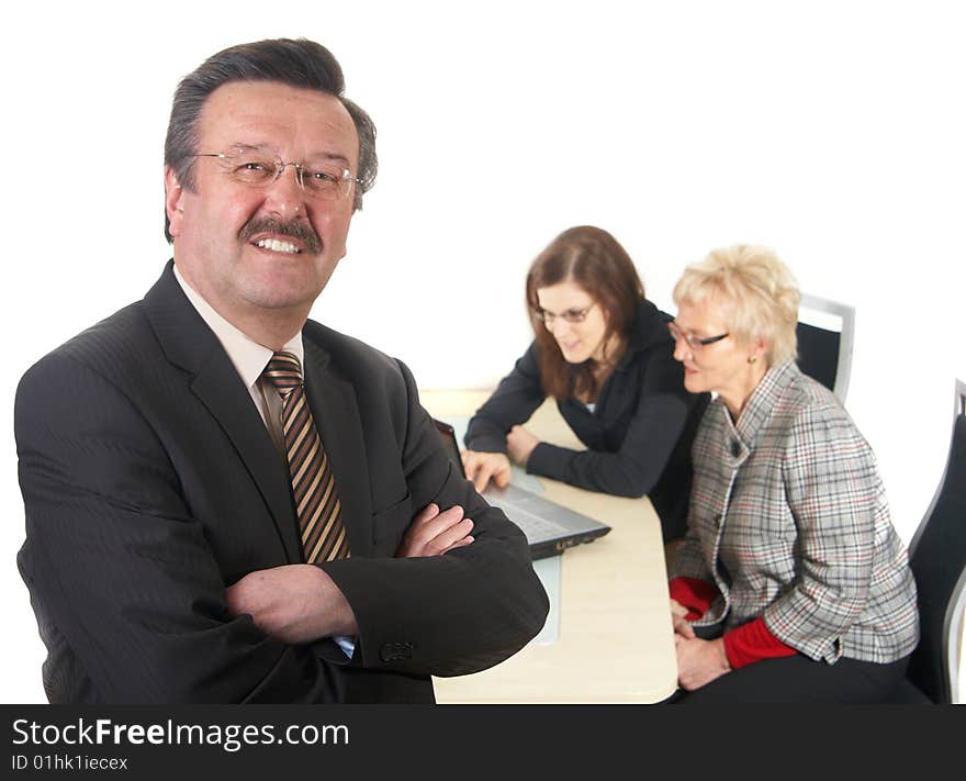 Businessman in office environment. Three people with focus on mature boss in front. Isolated over white. Businessman in office environment. Three people with focus on mature boss in front. Isolated over white.