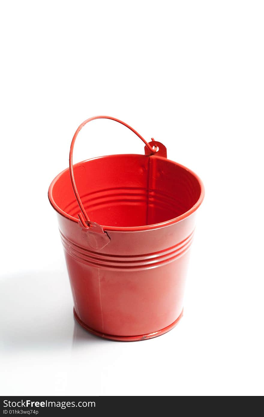 Closeup of small red metal bucket.