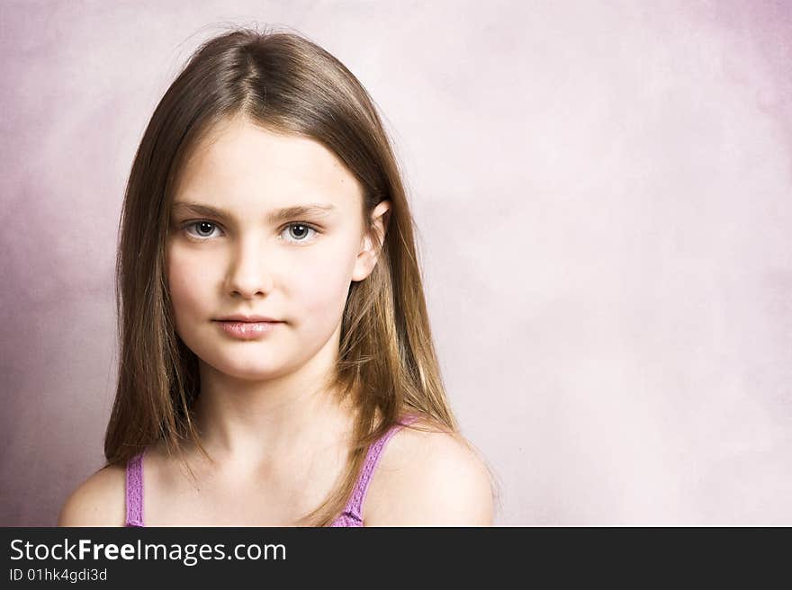 Beautiful young brunette against a pink background. Beautiful young brunette against a pink background