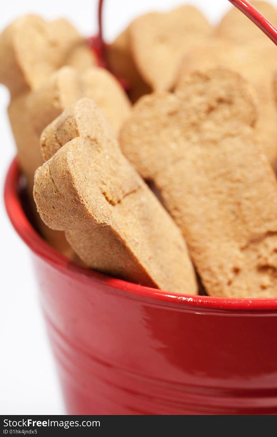 Closeup of brown dog treats in a red bucket. Closeup of brown dog treats in a red bucket.