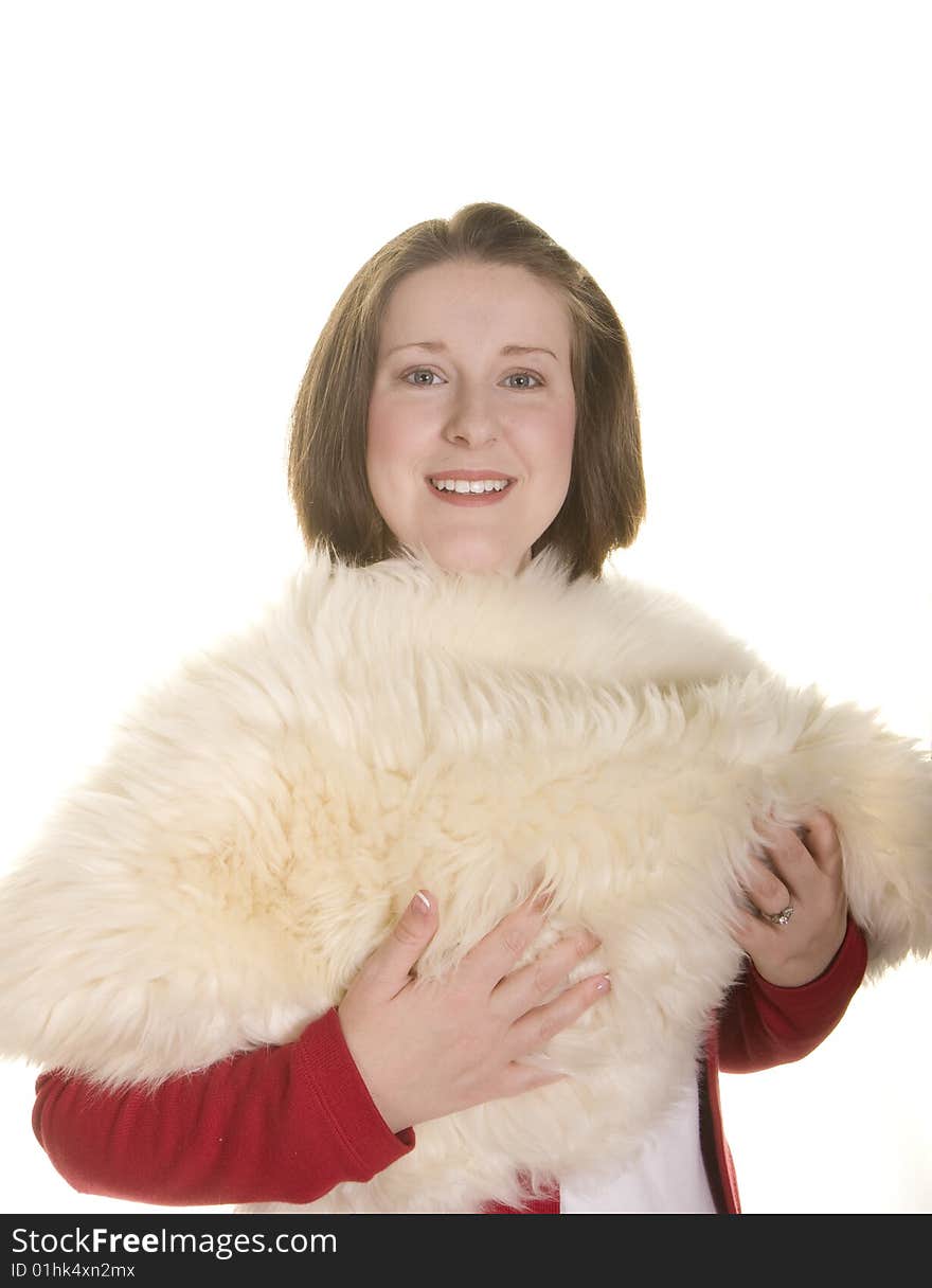 A young woman with a nice smile holding a white fur. A young woman with a nice smile holding a white fur