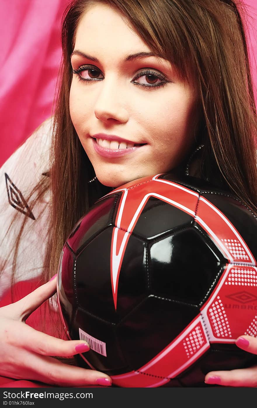 Female model staring into the camera smiling with her chin on the ball. Female model staring into the camera smiling with her chin on the ball