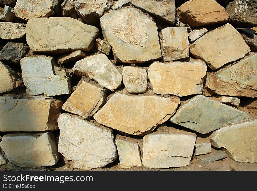 The old stone masonry wall. The old stone masonry wall