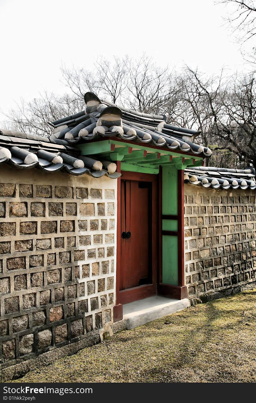 Buddhist Temple Gate against wooded background