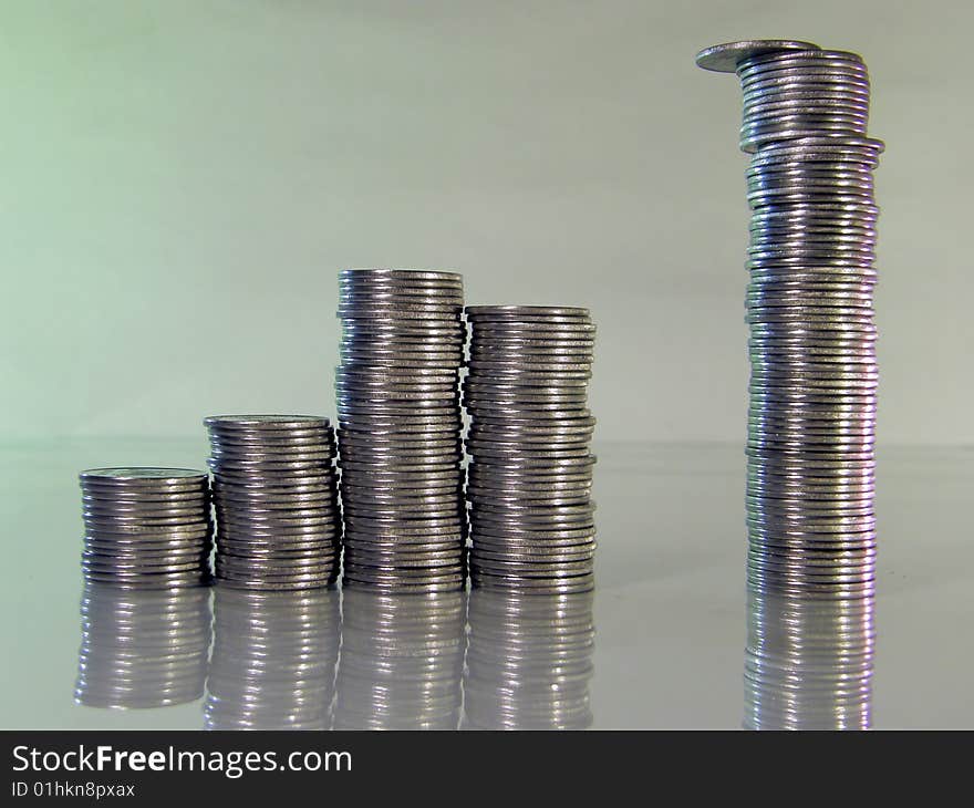 Diagram consisting of piles of coins, denotes the artificial creation of the financial crisis